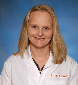 Bio photo of Dr. Amanda Dykstra, smiling in a white lab coat